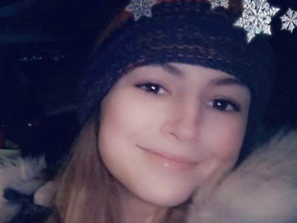 A young woman with long hair, wearing a toque.
