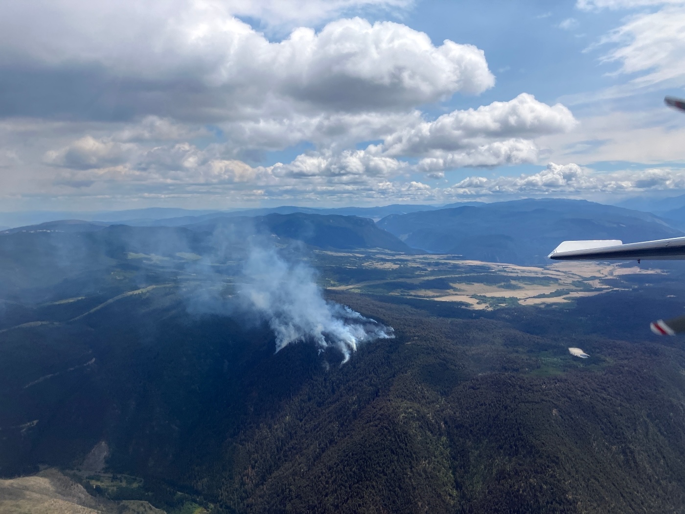 An aerial image of a relatively small fire, with smoke but no flames visible.